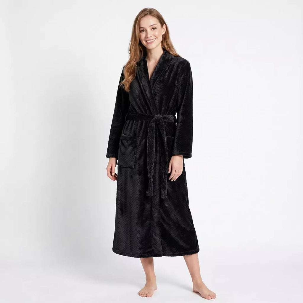 Kvinna bär svart morgonrock från Gaubert® med fiskbensmönster och mjuk coral fleece.